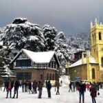 Tourist enjoying Snowfall in The Ridge, Shimla, near the historic Christ Church