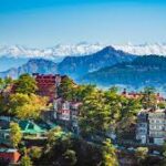 Shimla Hill Station, with its colorful buildings and a beautiful view of snow-capped Himalayan Mountains.